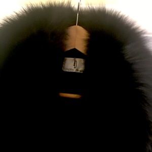 Timothy Daniels black coat with black fur collar.